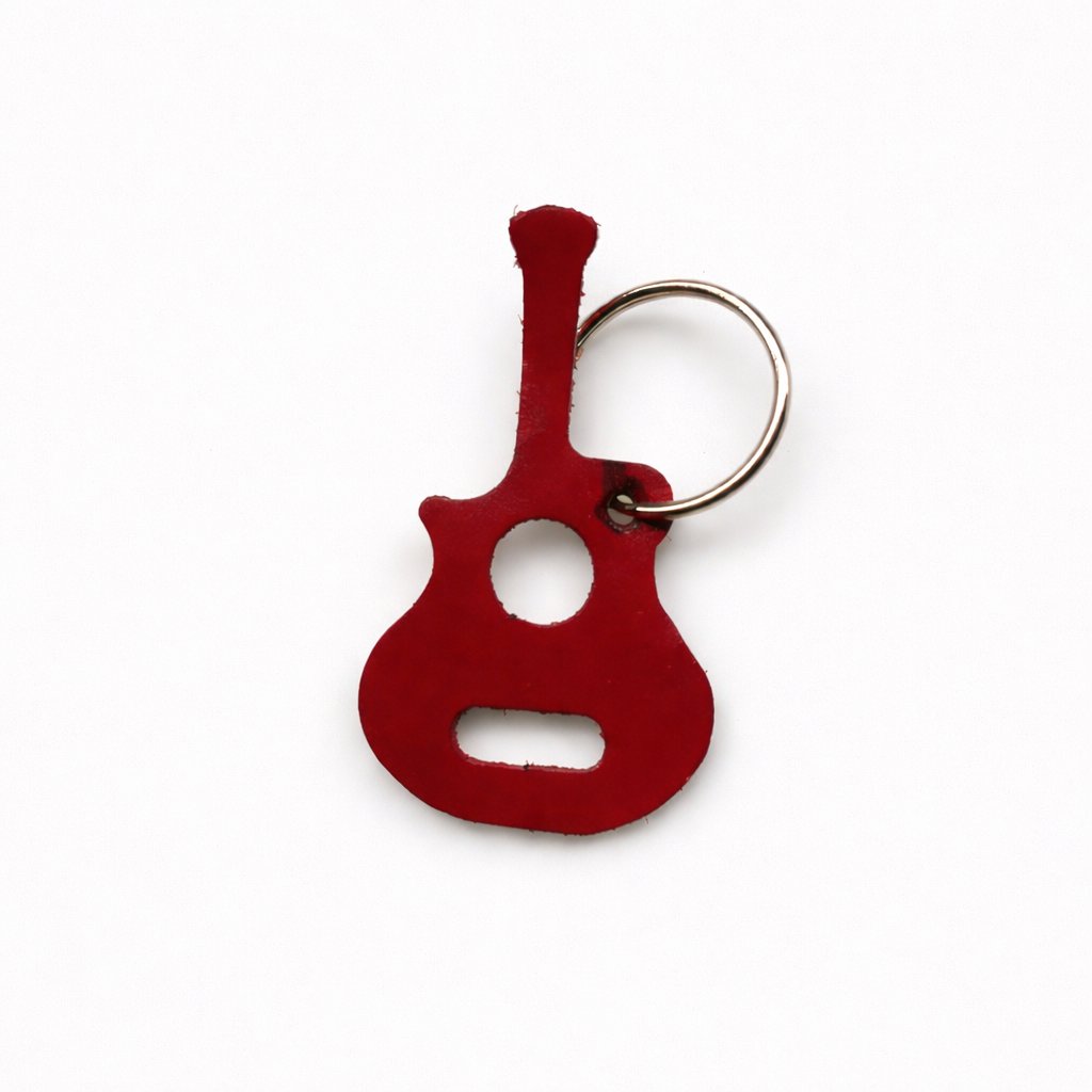 Red guitar-shaped keychain on a white background